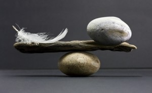 Balancing a feather and a rock